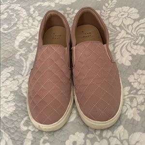 a pair of rose gold slip-on platform shoes